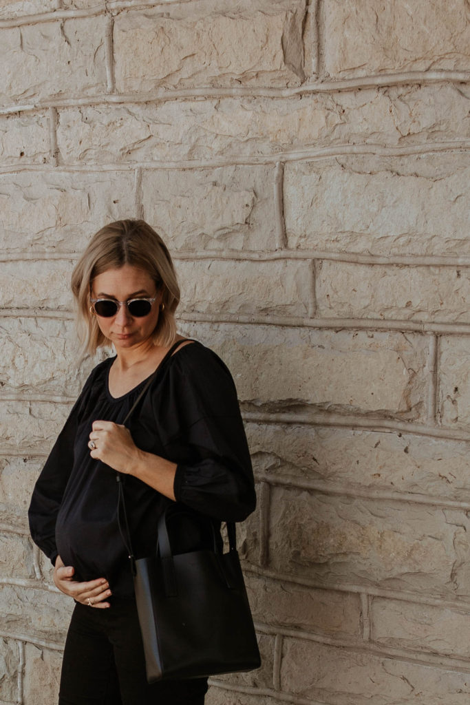 An all black outfit, outfits that transition to fall, maternity style, new in at everlane, everlane day tote mini, everlane air ruched blouse, all black summer outfit, clear framed glasses